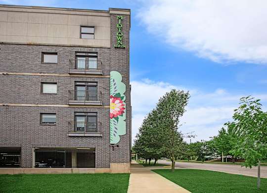 A building with a green sign on the side of it.