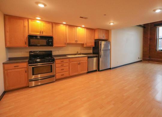 A kitchen with wooden cabinets and stainless steel appliances.