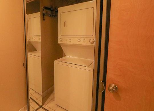 A white washing machine and dryer in a small laundry room.