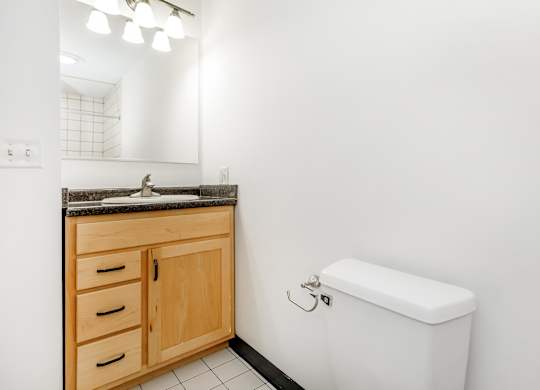 A white toilet sits next to a sink in a bathroom.