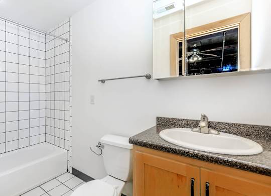 A bathroom with a white toilet, a white sink, and a white bathtub.