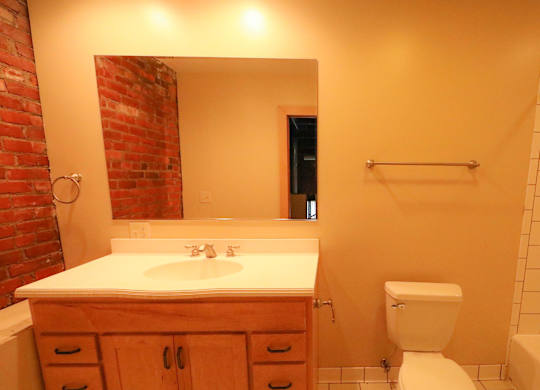 A bathroom with a white toilet and a white sink.