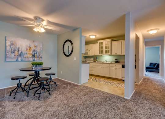 A living room with a dining table and chairs.