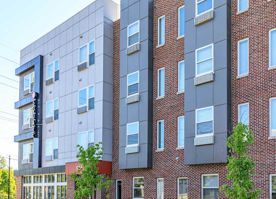 A modern building with a mix of brick and panel construction.