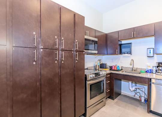 A kitchen with brown cabinets and stainless steel appliances.