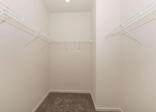 A small, empty room with a carpeted floor and white walls.