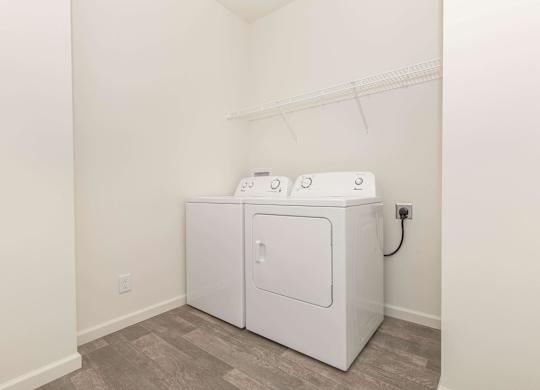 A white washing machine and dryer in a laundry room.