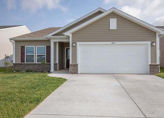 A house with a brown roof and a white garage door.