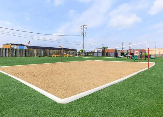 A baseball field with a sand pit in the middle.