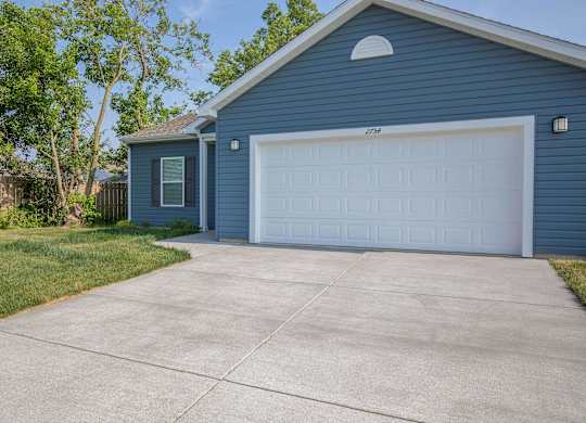 A blue house with a white garage door.