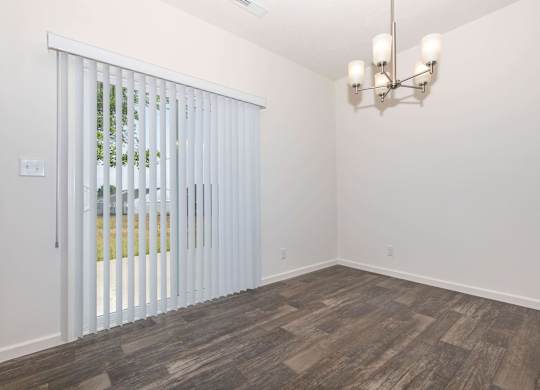 A room with a sliding door and a chandelier.