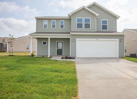 A two-story house with a garage door.