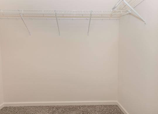 Empty room with a white closet rod.