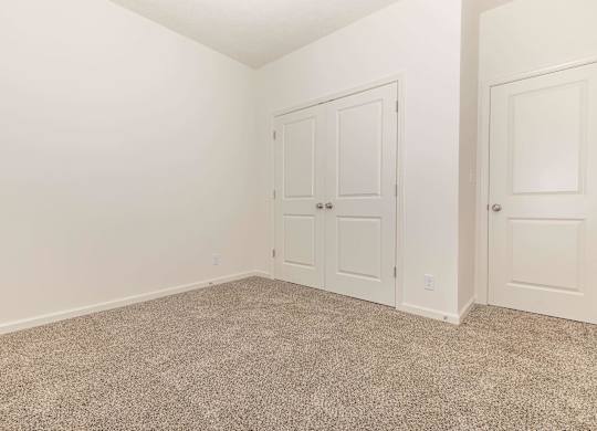 A room with a carpeted floor and white walls.