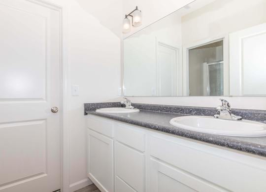 A bathroom with a white door and a white sink.