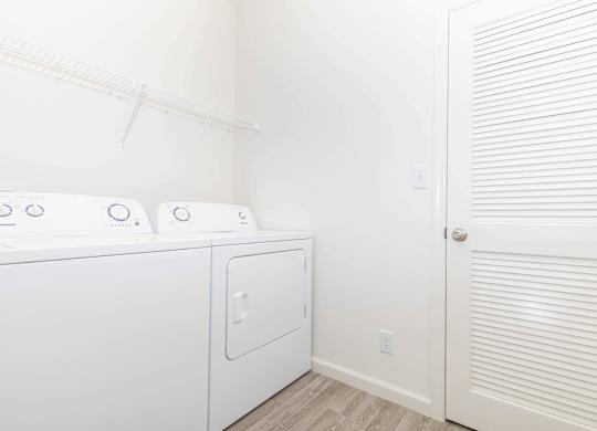 A white washer and dryer in a small laundry room.