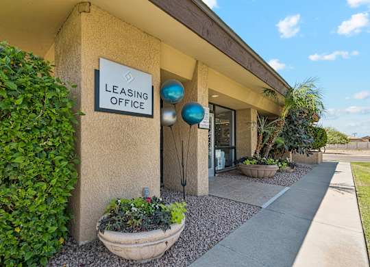 A building with a sign that says Leasing Office.