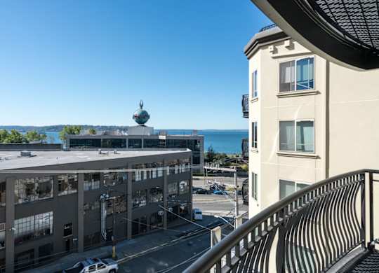 A building with a balcony overlooking the ocean.