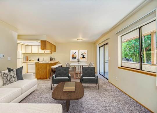 A living room with a white couch and a brown coffee table. at Autumn Village, Washington, 98354