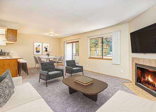 A living room with a fireplace and a television. at Autumn Village, Washington