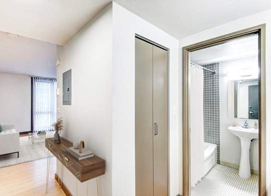 A bathroom with a white sink and a mirror.