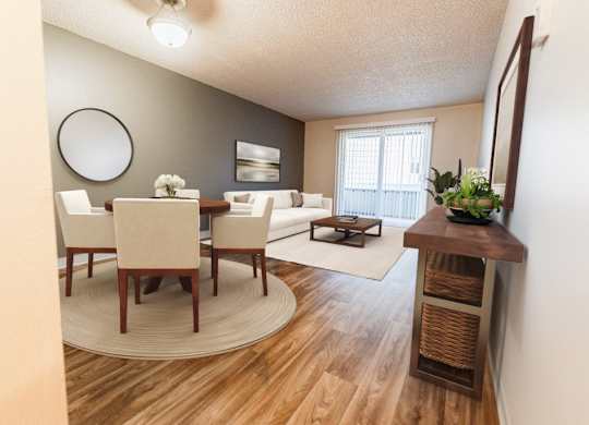 A dining room with a round table and chairs.