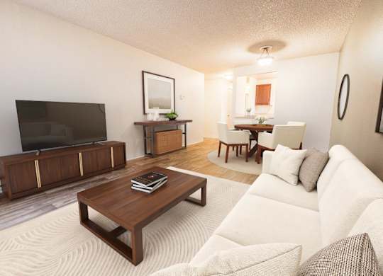 A living room with a white couch and a wooden coffee table.