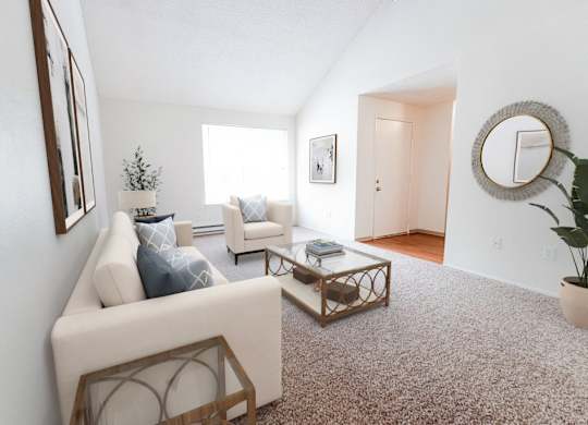 A living room with a white couch and a coffee table.
