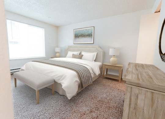 A bedroom with a large bed and a painting on the wall.