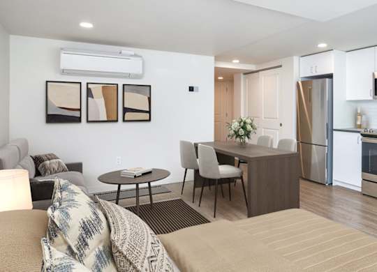 A modern kitchen with a dining table and chairs.
