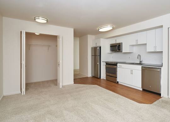 A kitchen with white cabinets and appliances is shown.