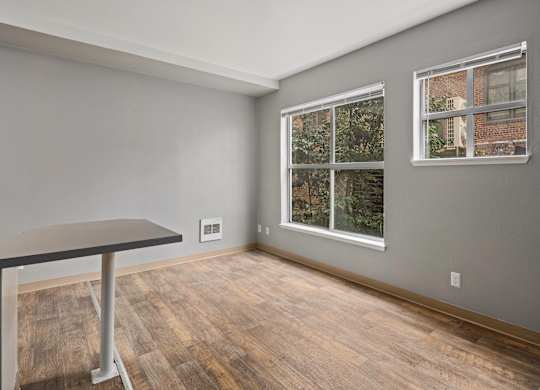 A room with a table and a window.