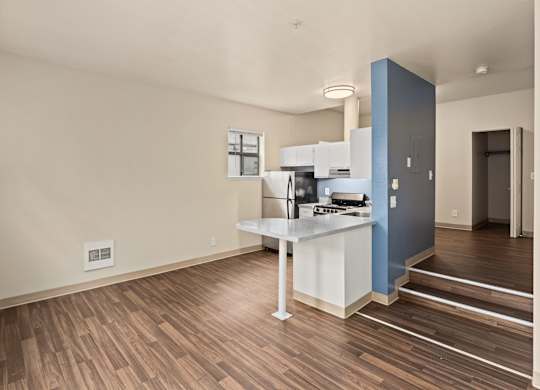 A kitchen with a white counter and a blue cabinet.