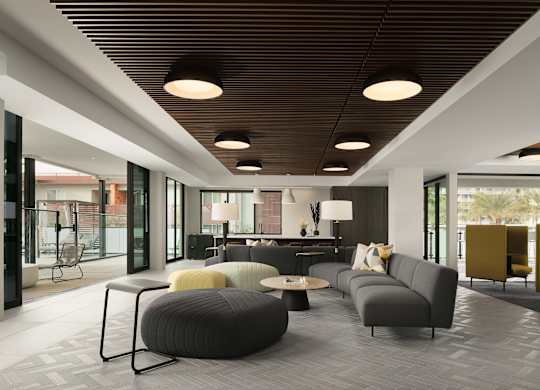 A modern living room with grey and yellow furniture.
