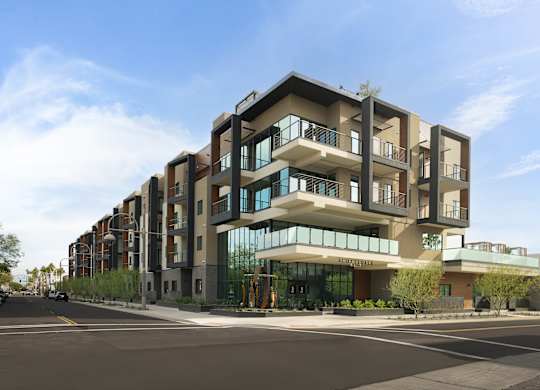 A modern apartment building with a clear blue sky above.