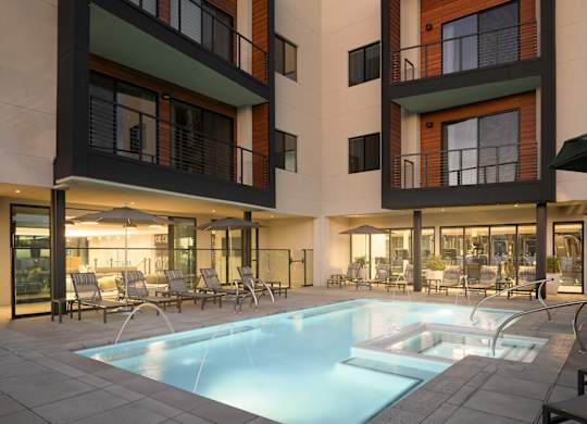 A modern building with a pool in front.