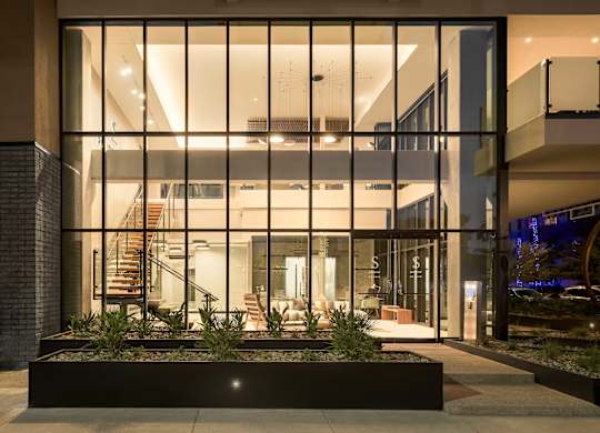 A modern house with a glass entrance and a staircase.