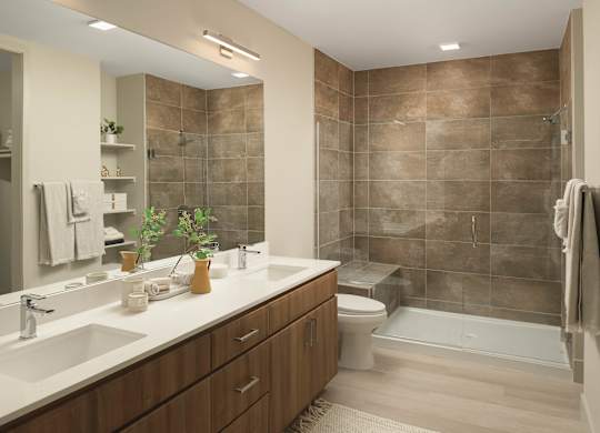 A bathroom with brown tiles and a white sink.