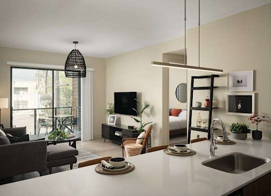 A modern kitchen with a dining area and a living room.