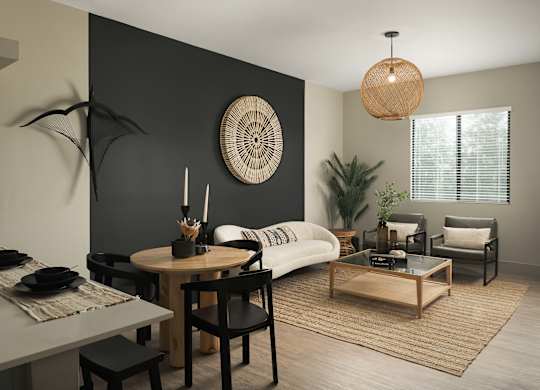 A modern living room with a dining table and chairs.
