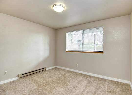 Seattle Apartments-  a bedroom with carpet and a window.