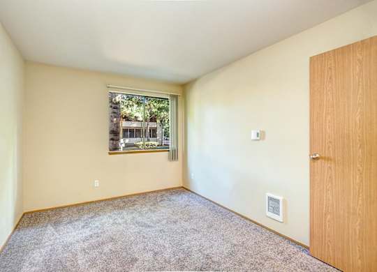 Empty room with a window and a door. at Autumn Village, Milton, WA