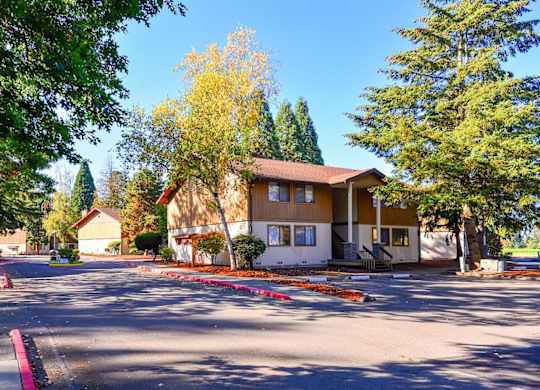 A house with a brown roof is surrounded by trees. at Autumn Village, Washington