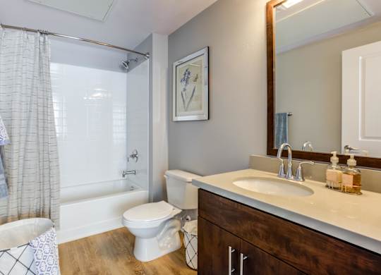 A bathroom with a white toilet, a white sink, and a white bathtub.