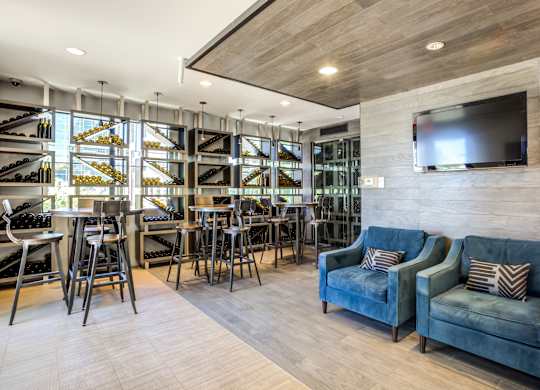 A modern living room with a bar area and a television.