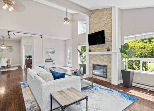 A living room with a white couch and a fireplace. at Brookstone, Washington, 98198