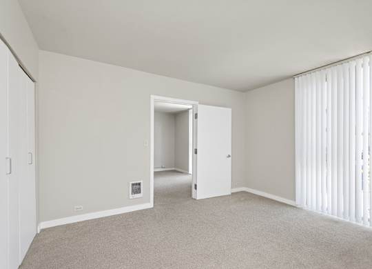 a bedroom with white walls and carpet at Cosmopolitan, Seattle, Washington
