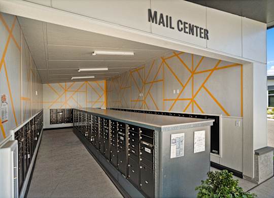 A mail center with a long row of mailboxes.