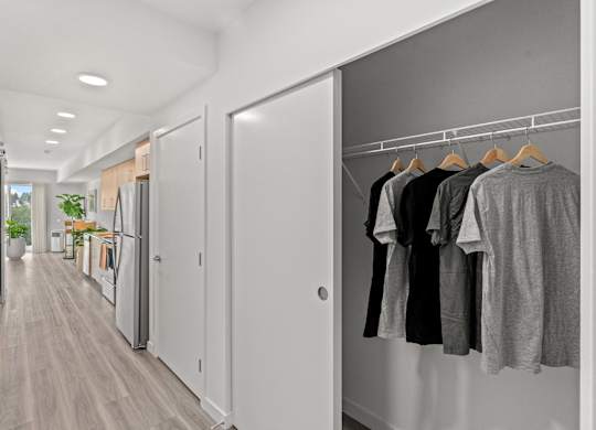 a hallway closet open with shirts hanging at Baldwyn, Seattle, WA