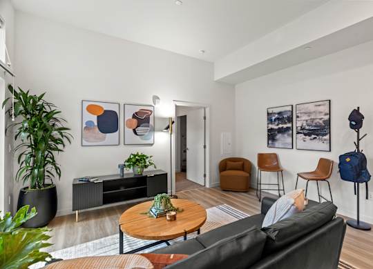 a living room with a leather couch and a coffee table and a tv at Baldwyn, Washington